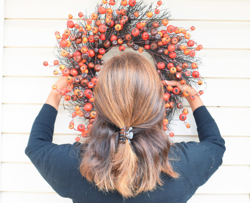 Fall decorating outdoors on vinyl siding